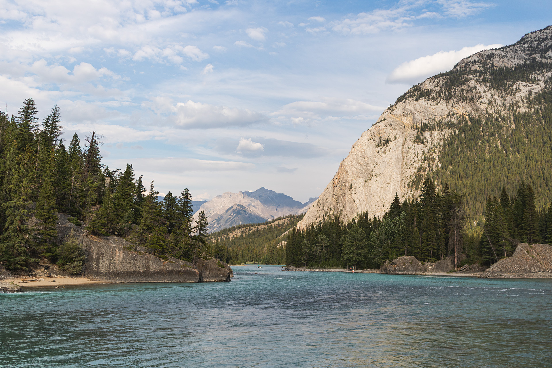 River flowing through a valley between two rocky mountains.